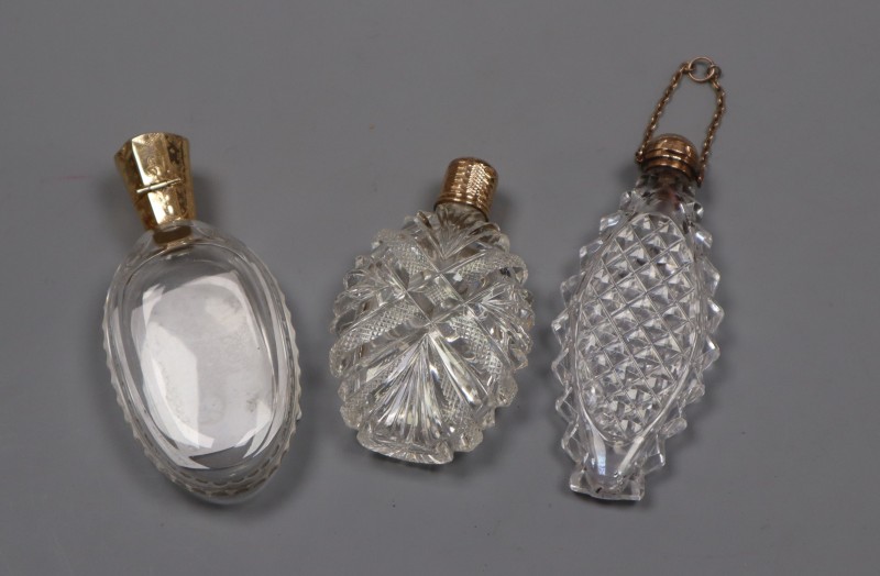 Three assorted 19th century cut glass scent bottles, including one with French yellow metal mount, largest 9cm.